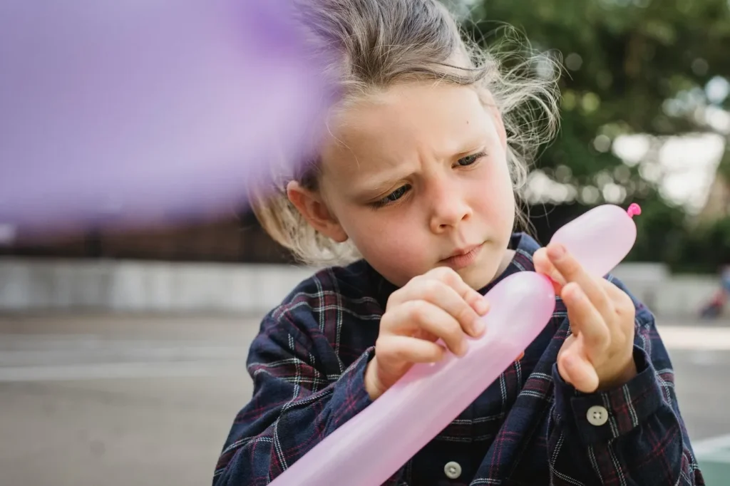 Child playing with a balloon during a Jubilee Church children’s event.